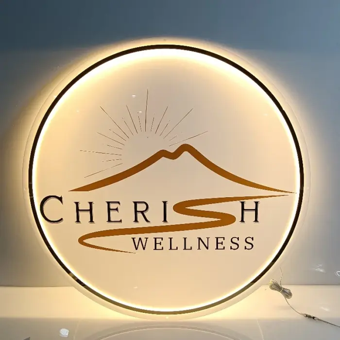 Personalized round neon business logo sign with CHERISH WELLNESS branding and warm white LED lights.