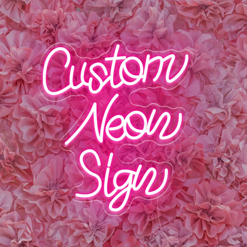 Pink custom neon sign letters glowing over a bed of pink rose flowers